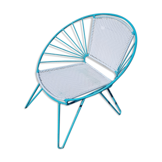 Old relax armchair in turquoise metal