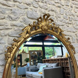 Oval mirror with pediment, beaded gilded with gold leaf
