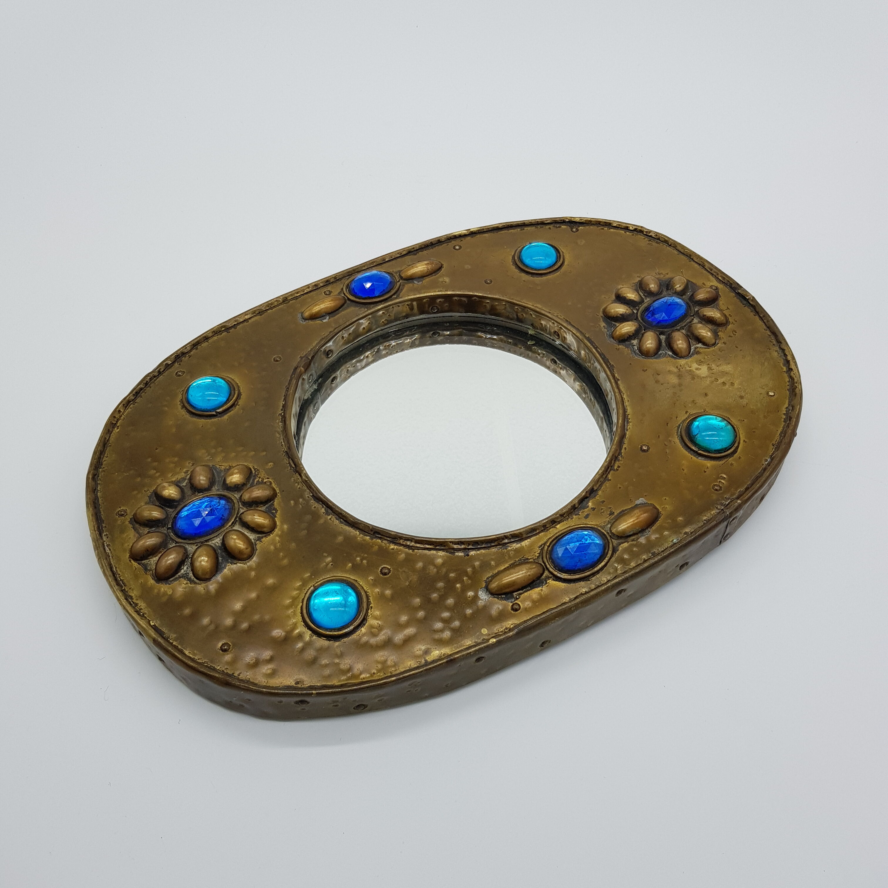 Brass oval mirror and blue cabochons