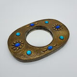 Brass oval mirror and blue cabochons