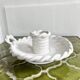 Hand-held candle holder with braided ceramic bowl