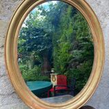 Golden oval mirror