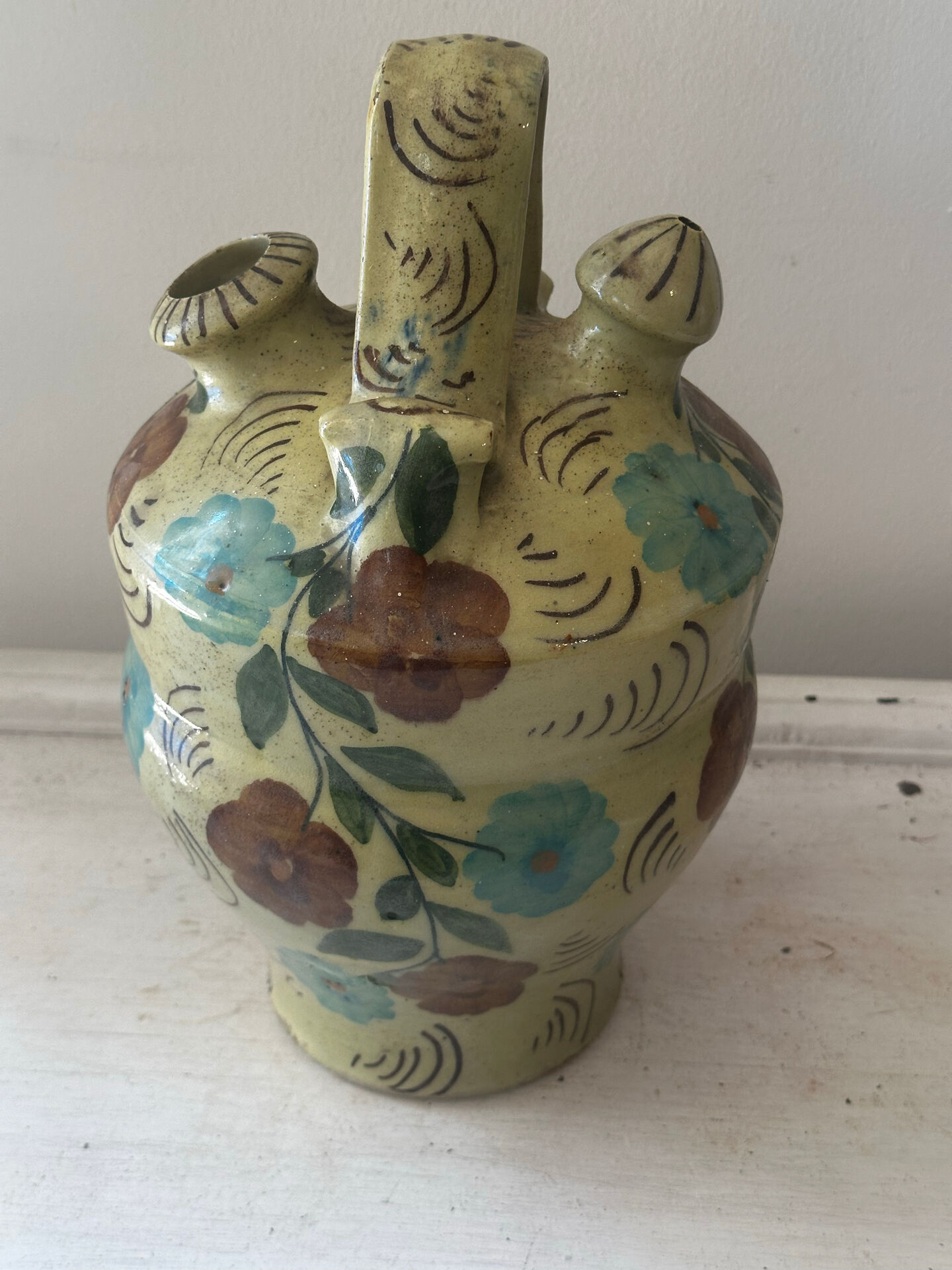 Mediterranean ceramic jug with floral decoration.