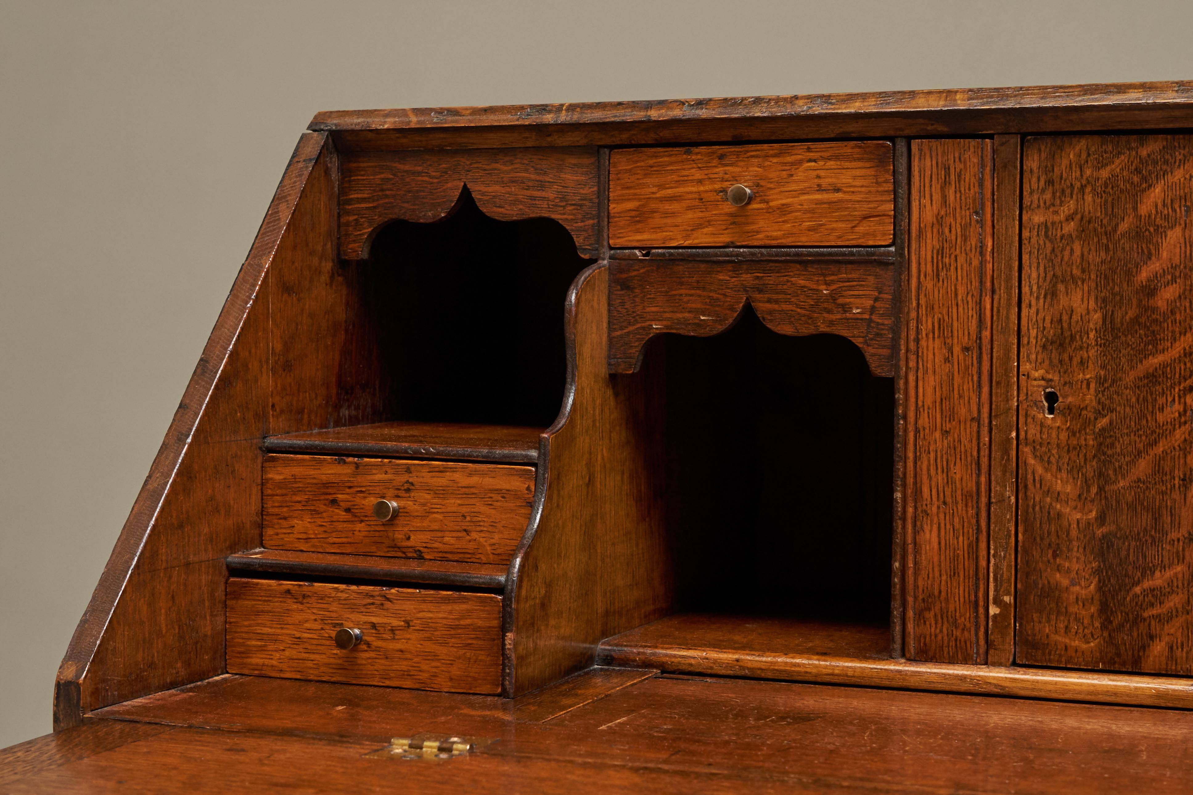 Antique English oak secretary with drop-down front.