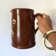 Terracotta pitcher with hand-painted bird decor