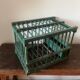 old bird cage made of wood and painted green
