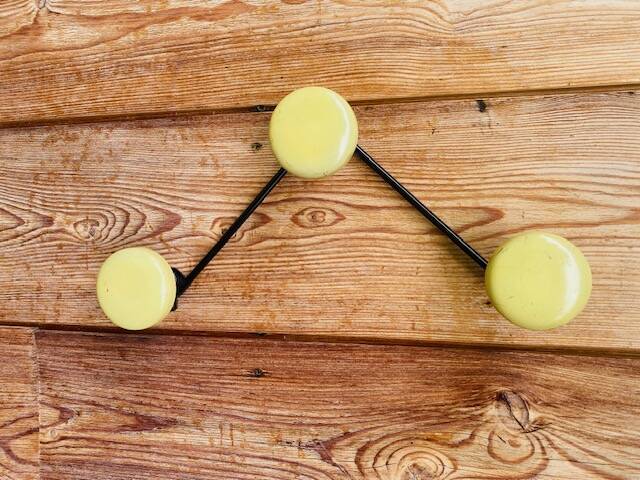Vintage yellow wall coat rack