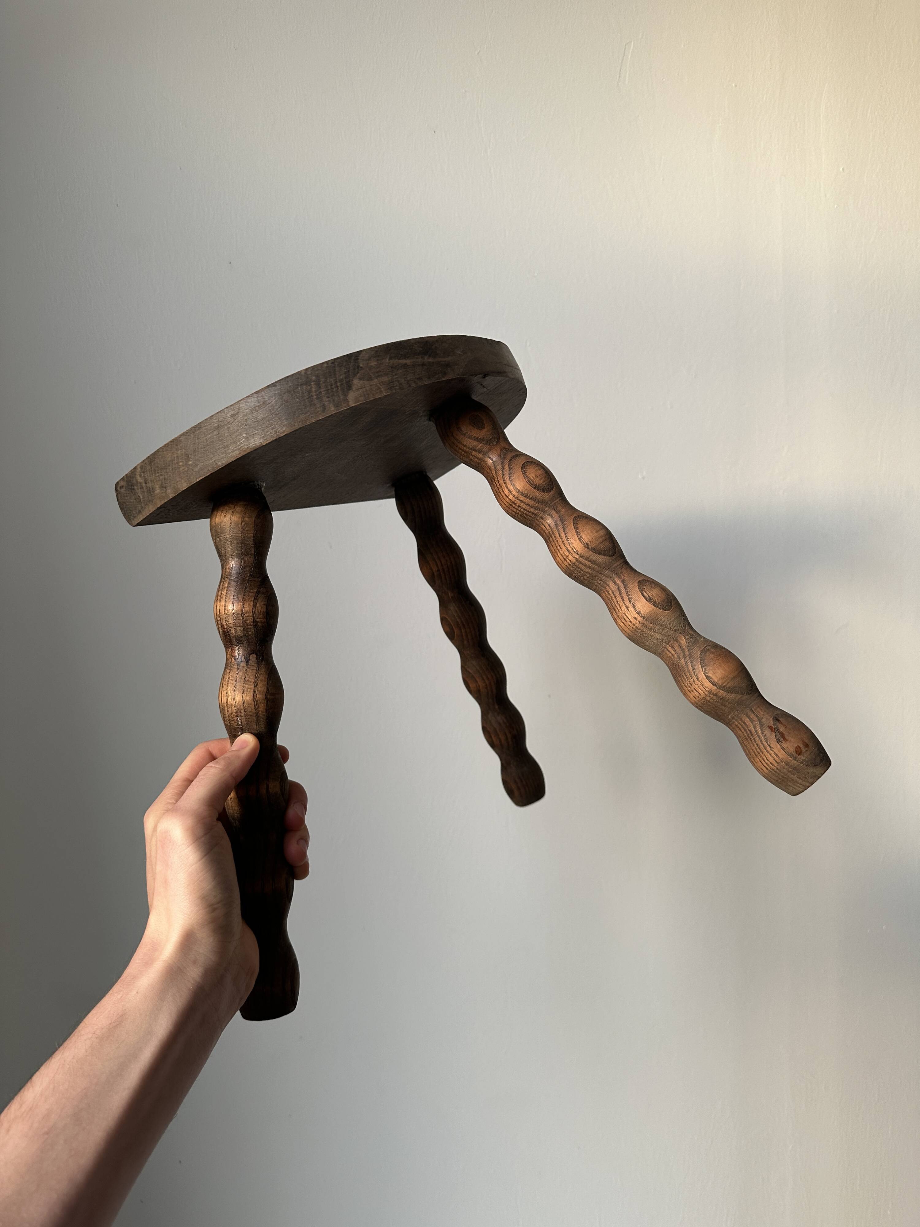 Wooden bench with three twisted legs