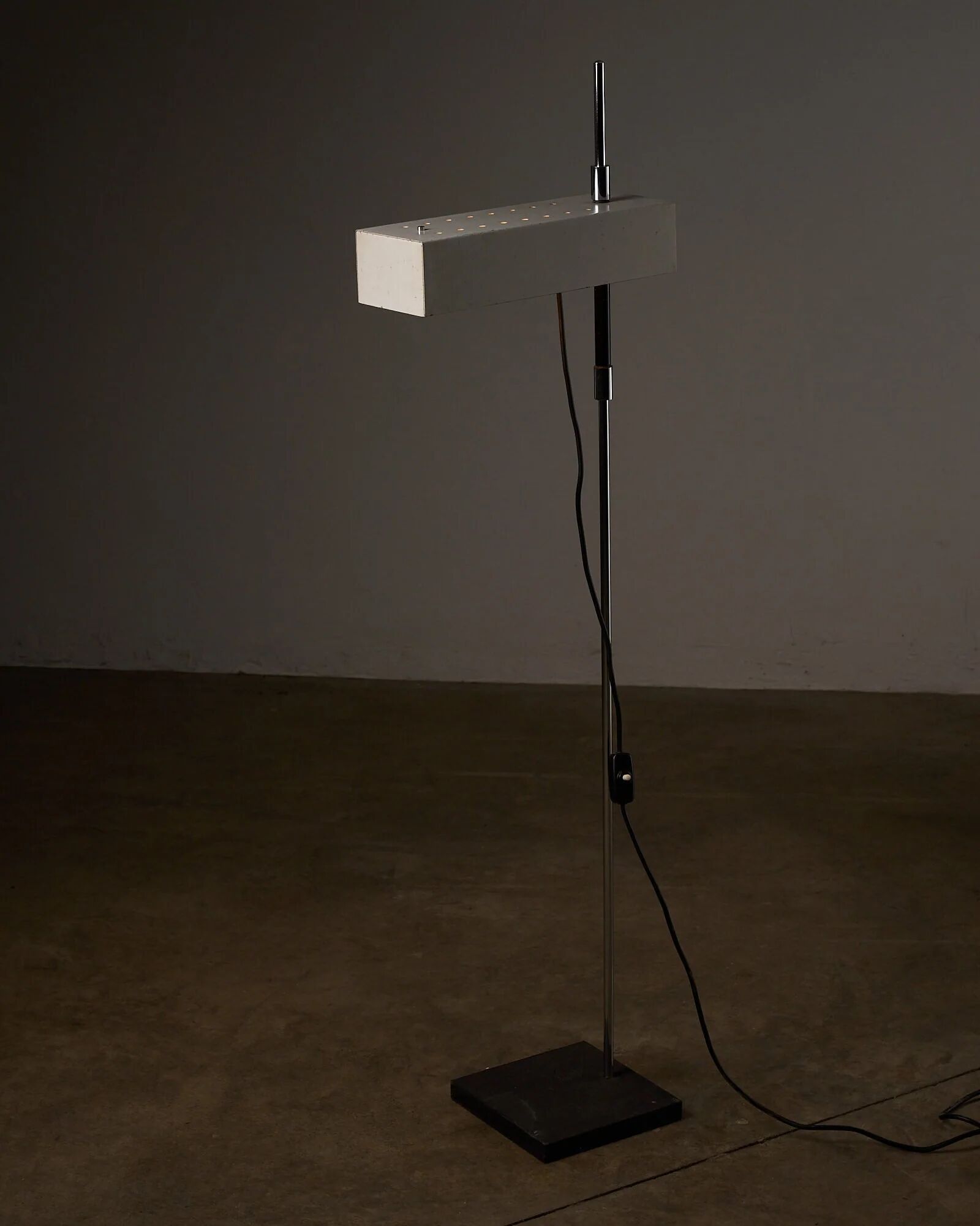 Adjustable perforated shade floor lamp