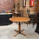 Modular round teak table with central base by Osvaldo Borsani.