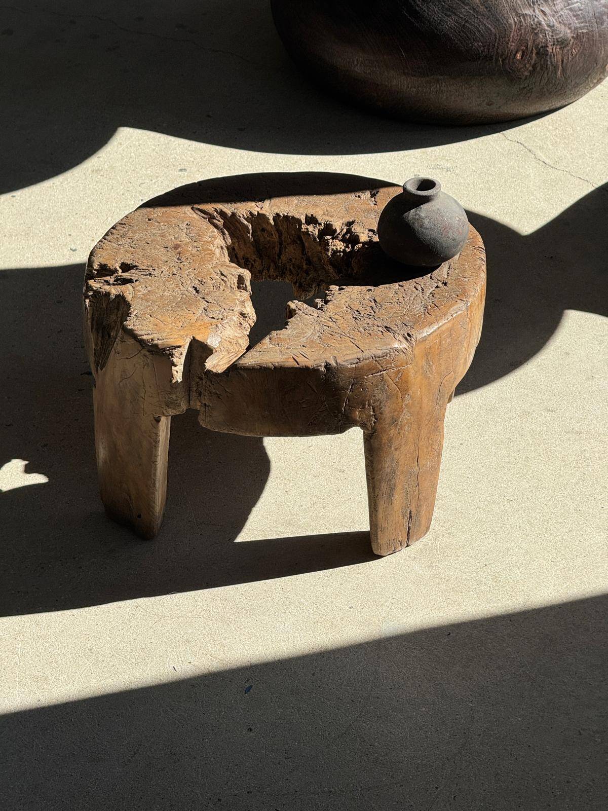Small low circular four-legged stool in organic old teak with cut-out design H2