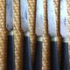 A set of 8 knives with black wooden handles and bolsters.