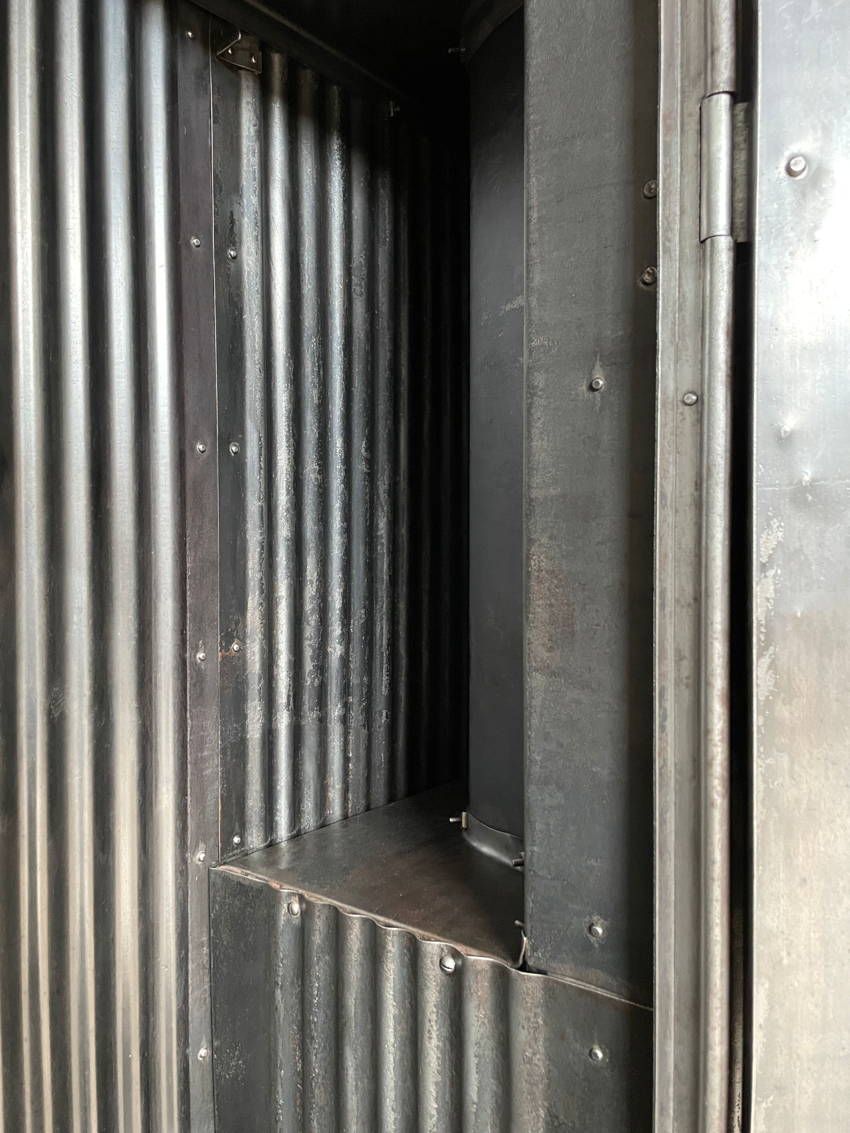 Strafor double-door corrugated iron cloakroom, circa 1920.