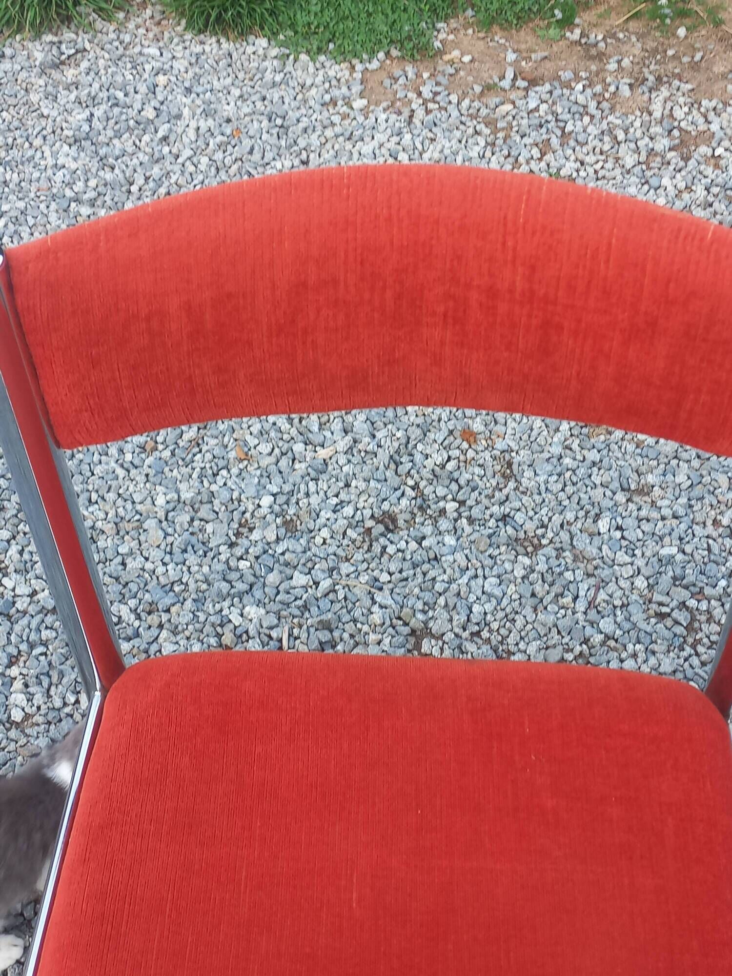 Pair of designer chairs in chrome metal and orange velvet from the 1970s.