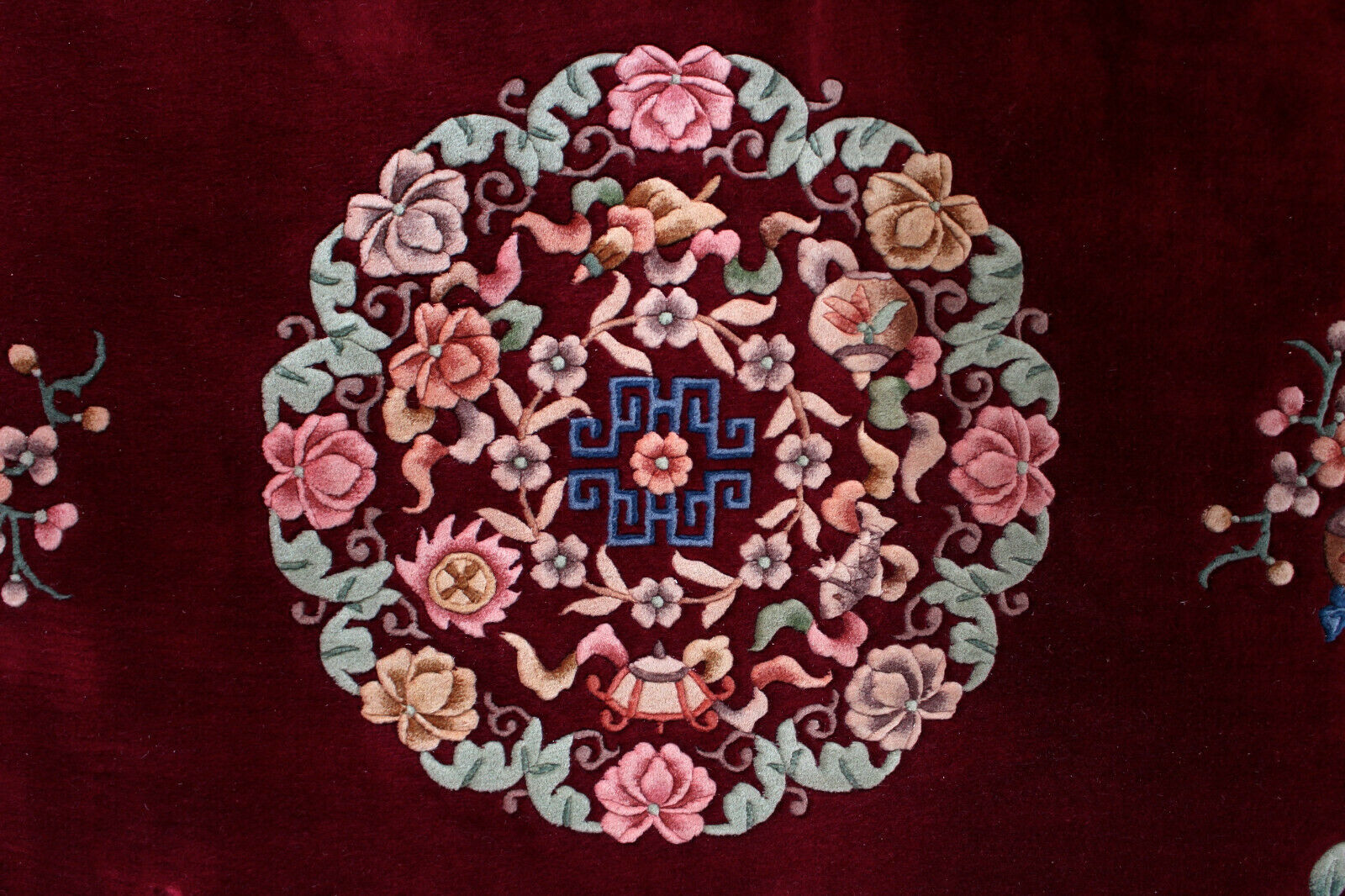 China wool fringed rug with floral pattern on deep plum background 393x274cm