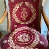 Paire de fauteuils Empire bordeaux à motif lyre , pieds sabre, accotoirs sculptés têtes de dauphin X