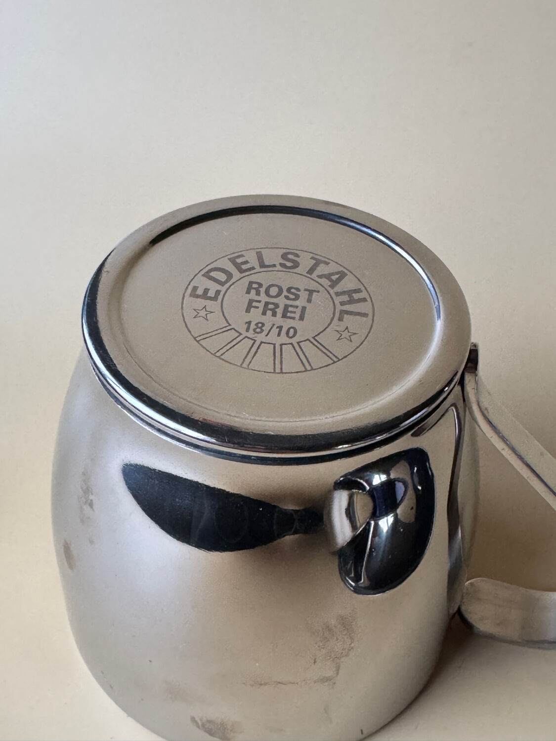 Two vintage mid century modern stainless steel coffee cups with saucer