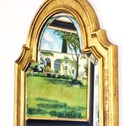 Florentine arched mirror in gilded wood with gold leaf.