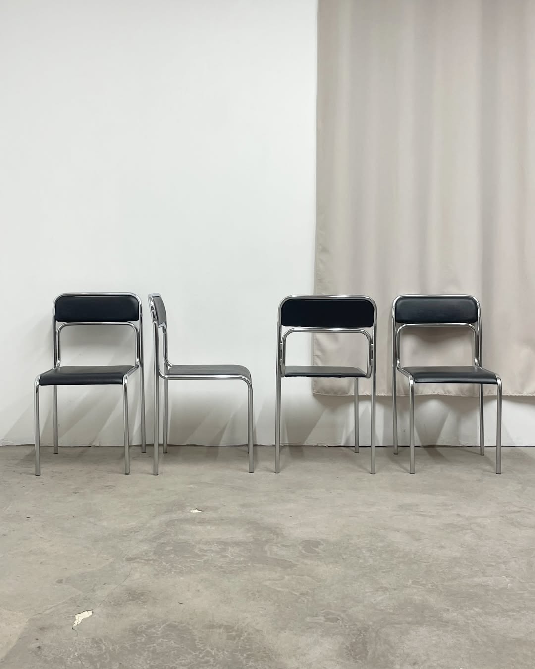 4 chrome metal chairs with black faux leather, 1990