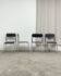 4 chrome metal chairs with black faux leather, 1990