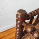Antique corner chair made of turned wood spindle.