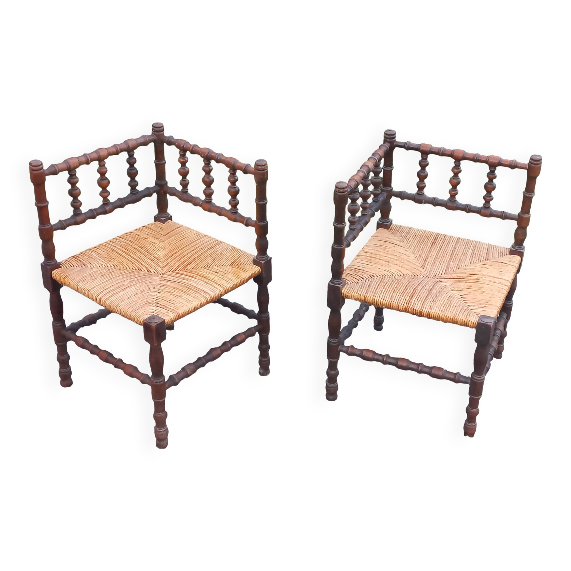 Pair of angled armchairs with turned wood and rush seats from the 1960s.