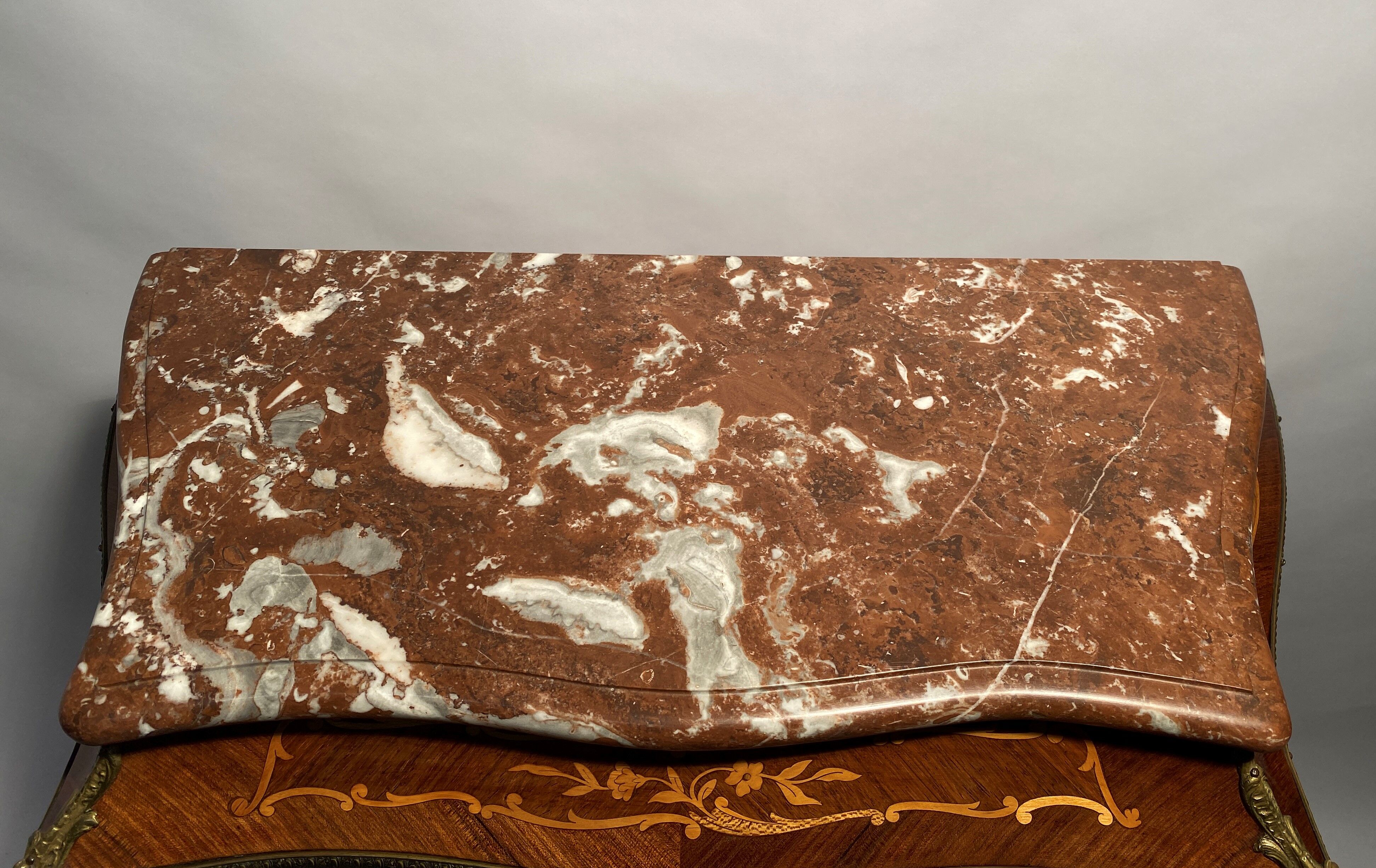 Curved secretary and inlaid with floral branches in Louis XV style