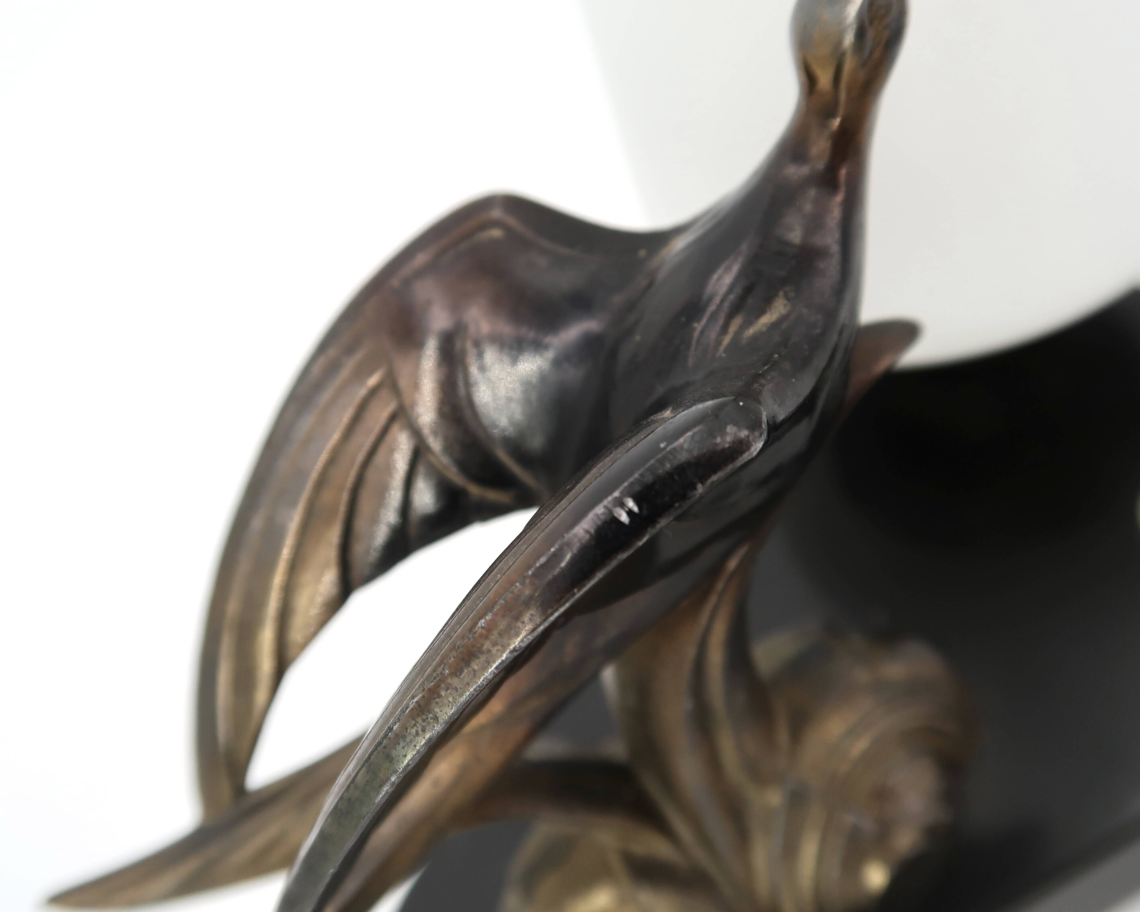 Art Deco lamp with swallow sculpture, marble base, opaque white globe.