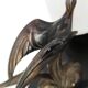 Art Deco lamp with swallow sculpture, marble base, opaque white globe.