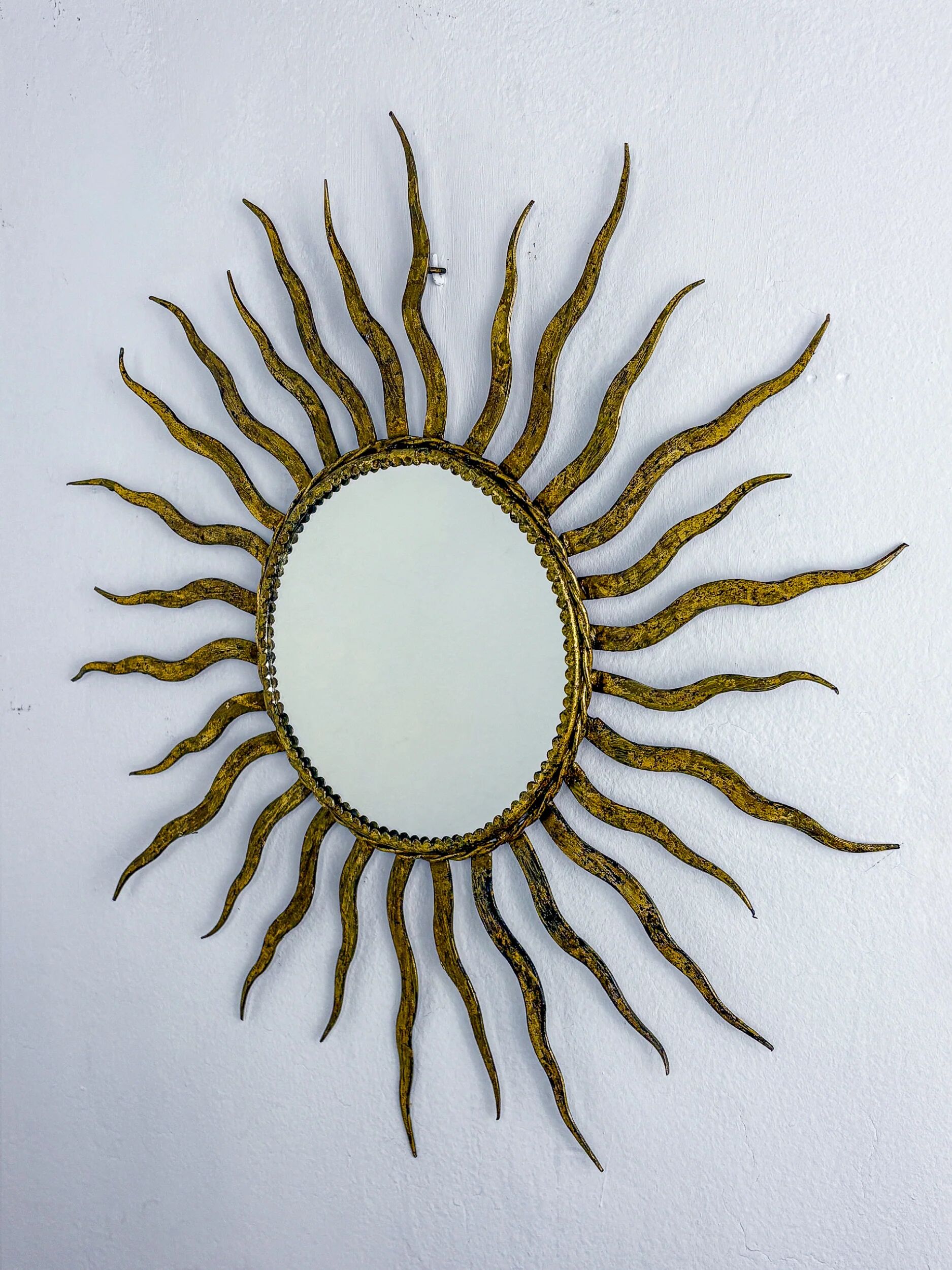 French sunburst starburst mirror in gilt iron, 1950s