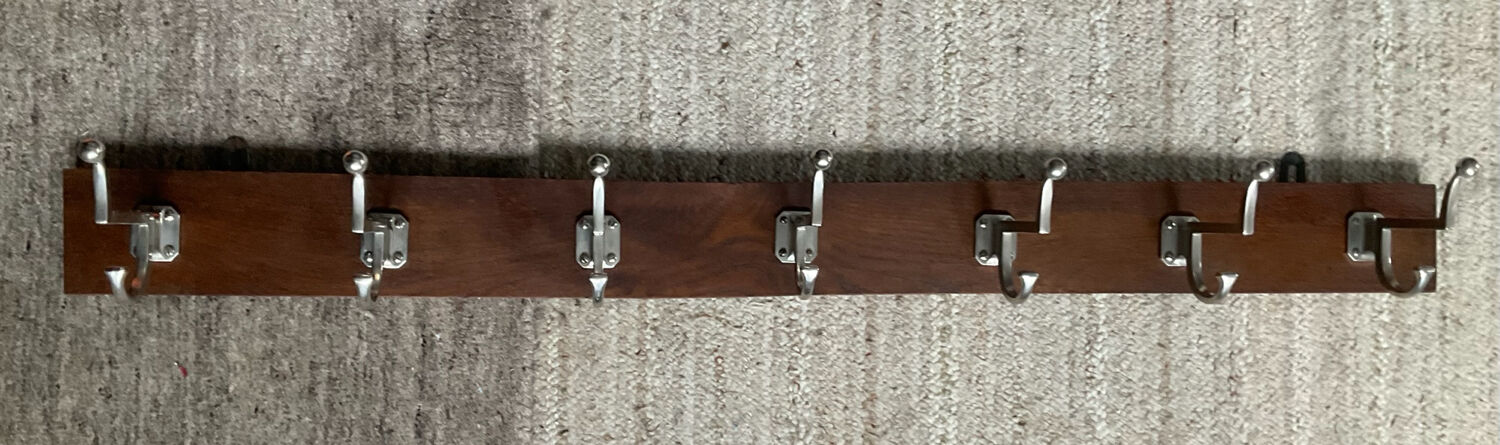 Wall coat rack from the 1950s-60s in solid oak and stainless steel.