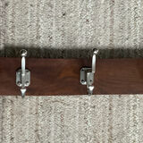 Wall coat rack from the 1950s-60s in solid oak and stainless steel.