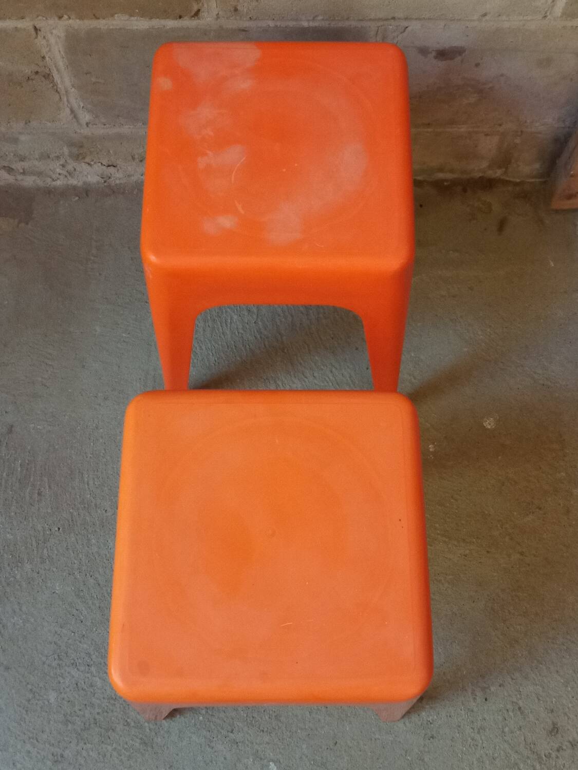 Pair of AMI stools in orange plastic