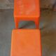 Pair of AMI stools in orange plastic