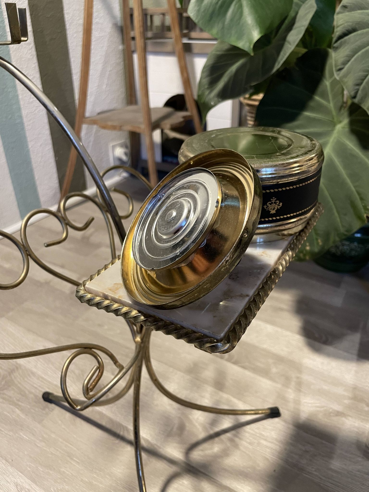 Gold wrought iron ashtray on legs with magazine rack and marbled shelf