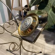 Gold wrought iron ashtray on legs with magazine rack and marbled shelf