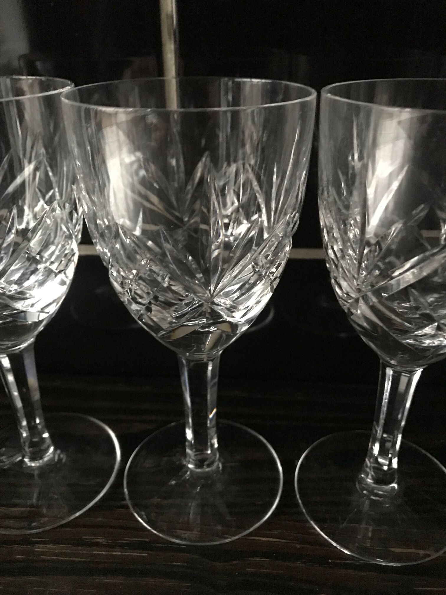 Crystal cut water stemmed glasses. Star and leaf patterns.