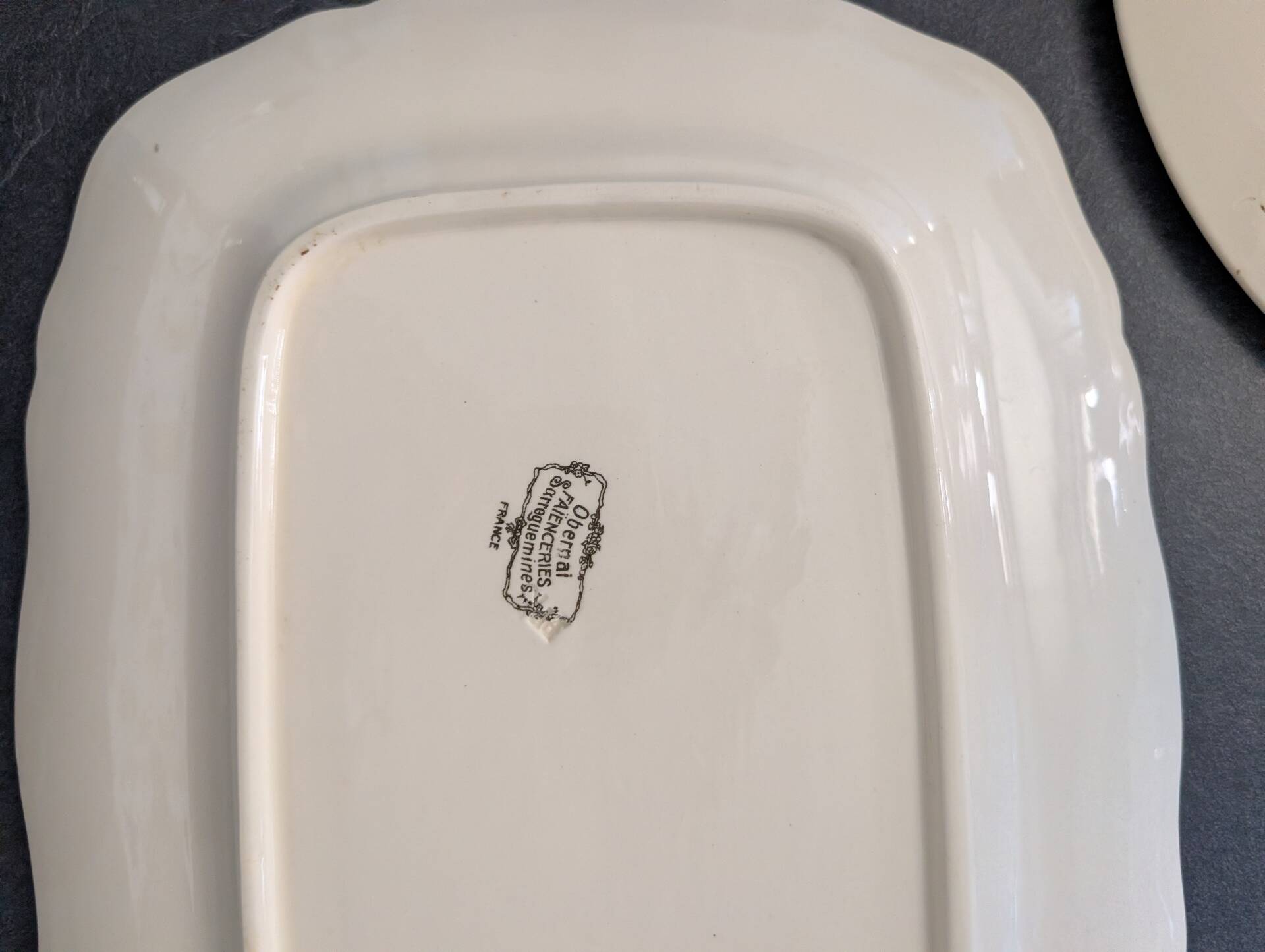 Two earthenware dishes from Obernai signed Henri Loux.