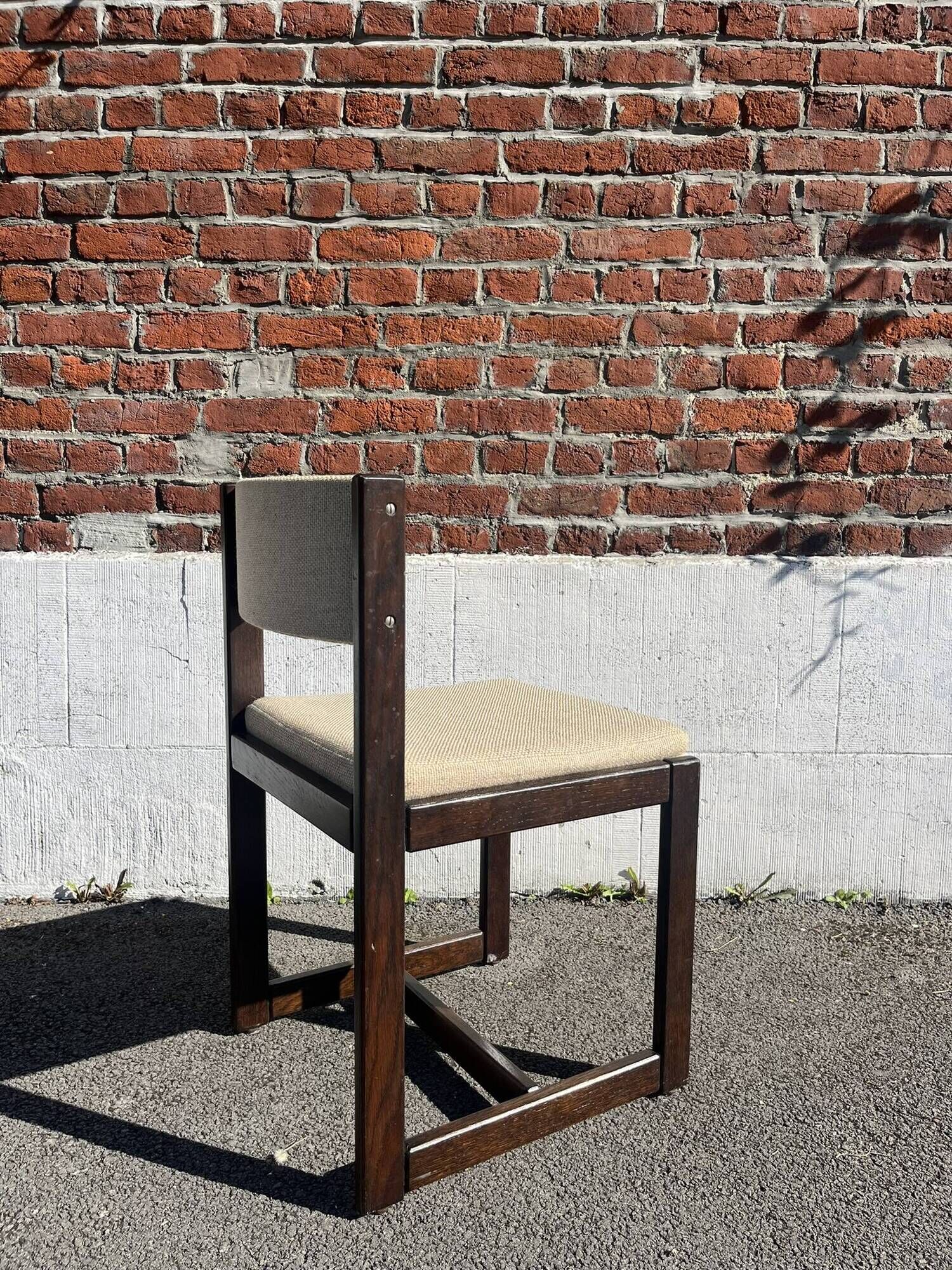 Many mid-century vintage wooden and fabric chairs.