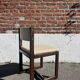 Many mid-century vintage wooden and fabric chairs.