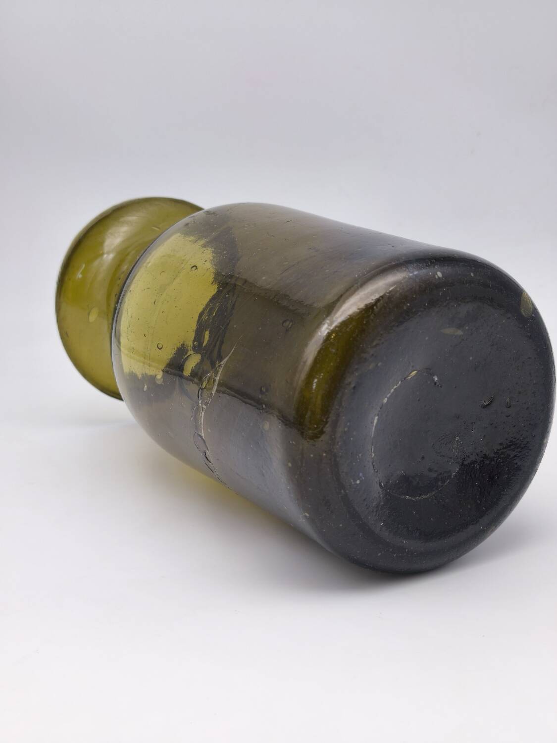 Old olive green blown glass mushroom jar, decorative object.