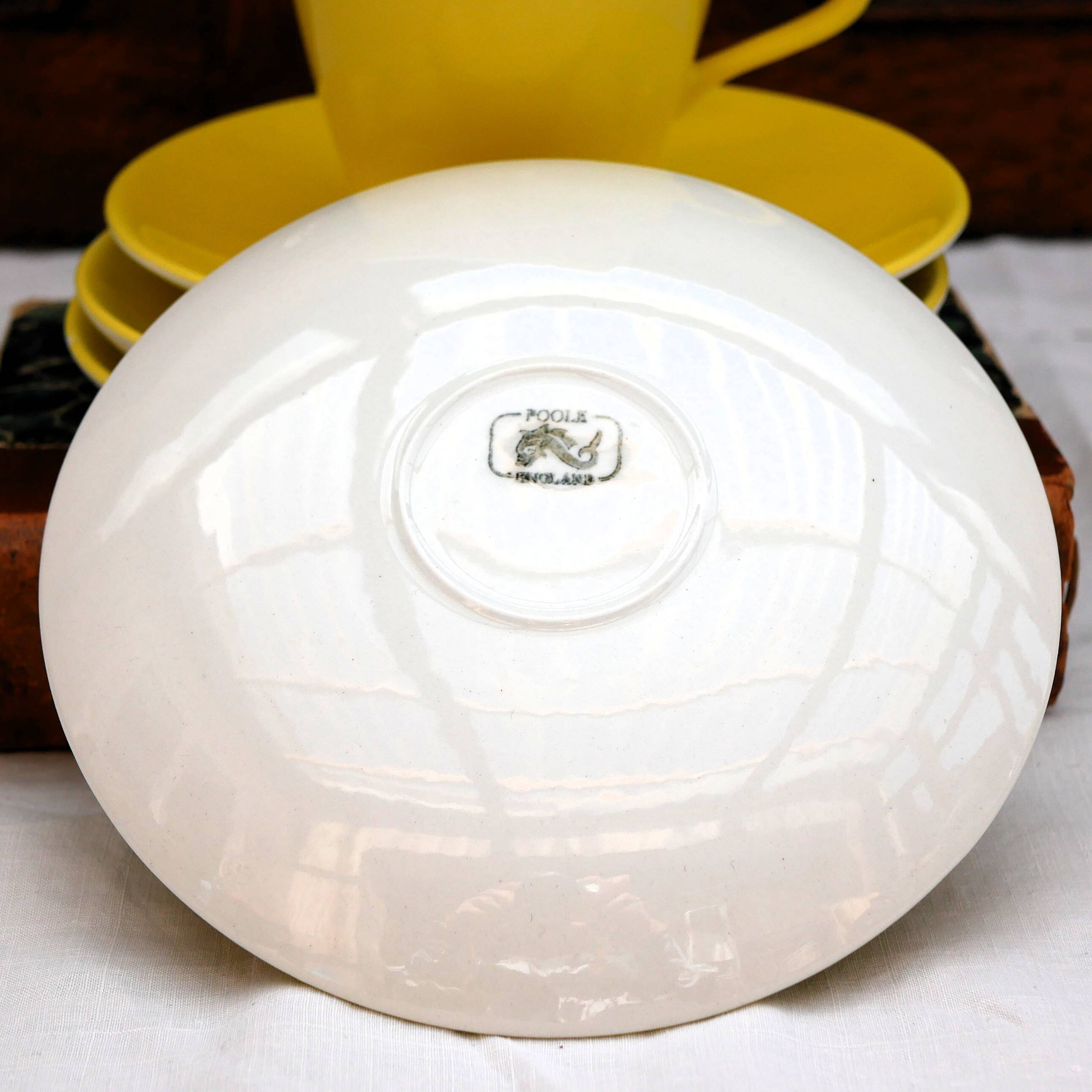 A pair of vintage bright yellow Poole Pottery - Two cups, saucers and ace