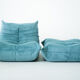 Ensemble de fauteuil et pouf Togo en velours côtelé bleu clair.