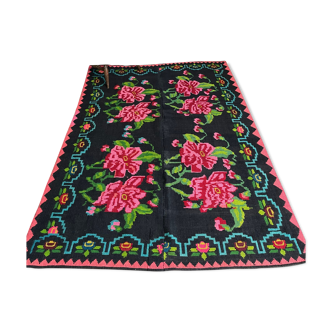 Romanian wool handwoven carpet with large pink flowers on black background