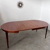 Round teak table with Scandinavian design extensions from the 60s vintage