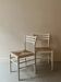 Pair of vintage white wood and straw chairs