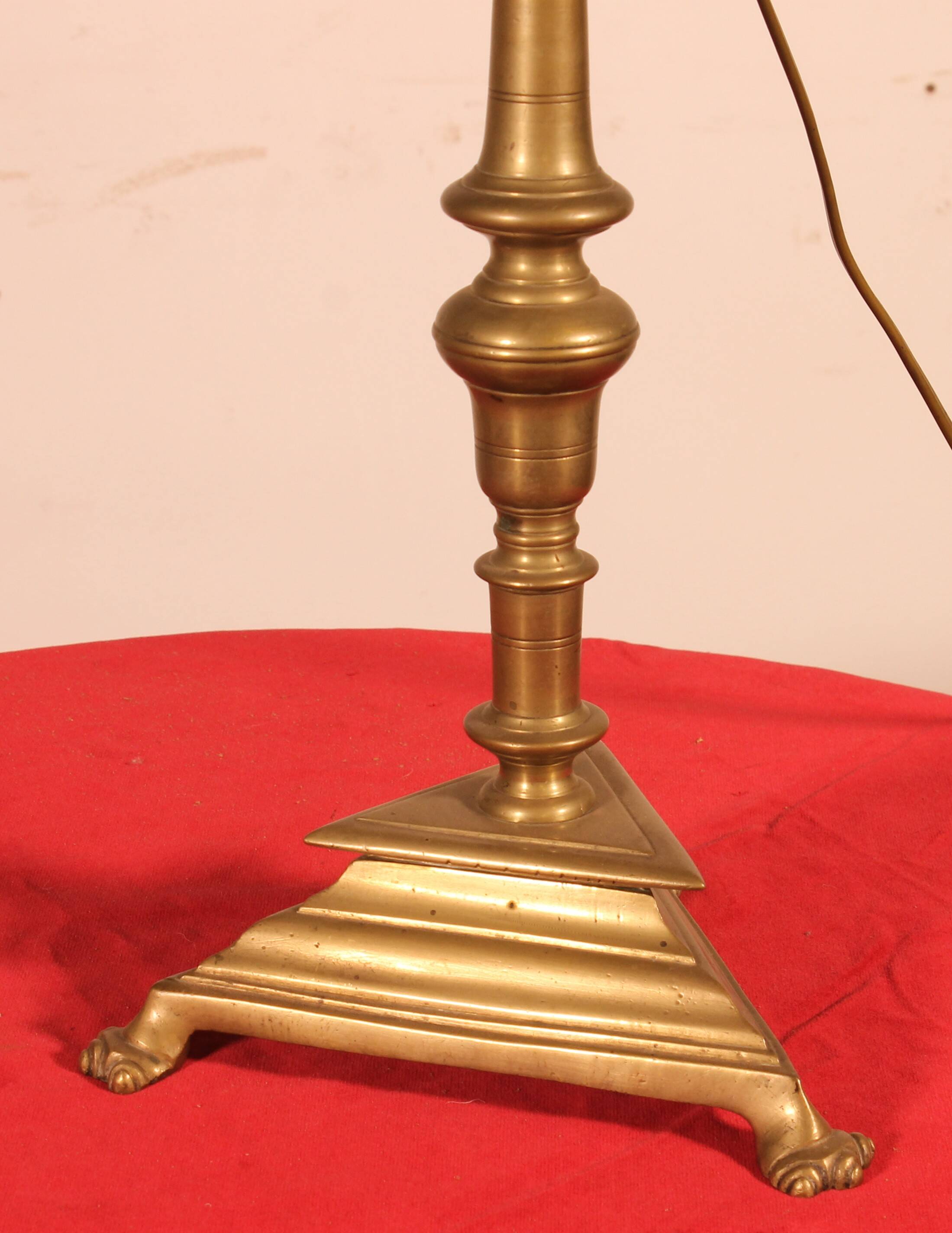 bronze candlestick from the 17th century converted into a lamp with its lampshade