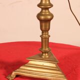 bronze candlestick from the 17th century converted into a lamp with its lampshade
