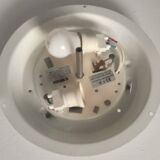 Round ceiling light with a wrought iron frame.