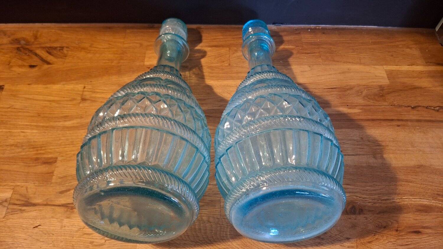 Pair of cut blown glass carafes in blue-green from the 19th century.